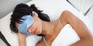 Woman sleeping in eye mask and ear plugs