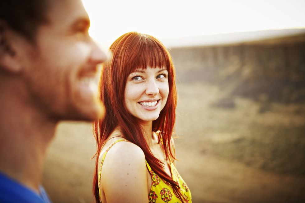 Woman smiling at boyfriend at sunset