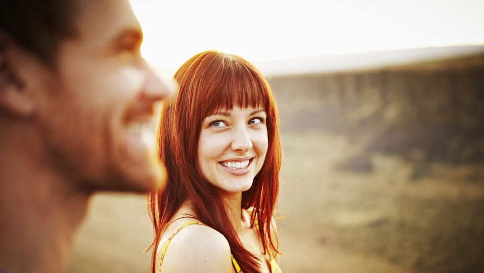 Woman smiling at boyfriend at sunset