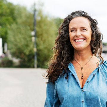 woman smiling, looking away
