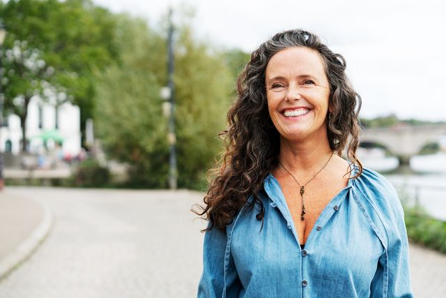woman smiling, looking away