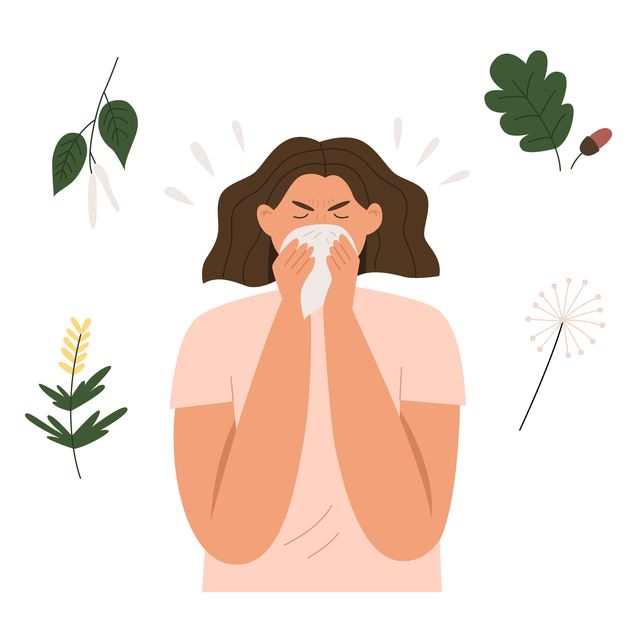 woman sneezes from plant allergy