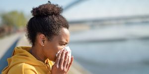 working out with allergies, woman sneezing