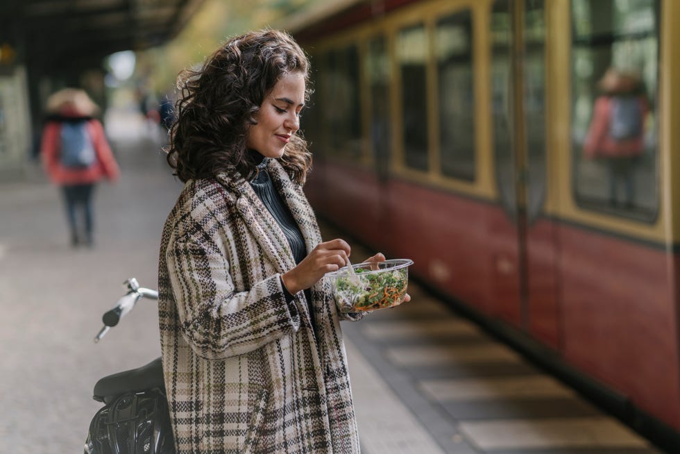 woman standing and eating