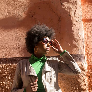 woman standing on a wall in the medina and looking to the right