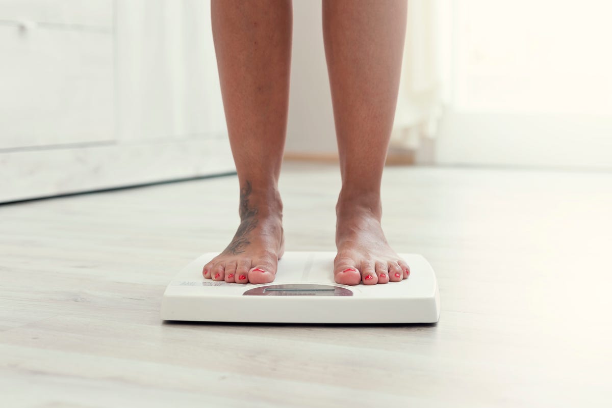 woman standing on the weight scale