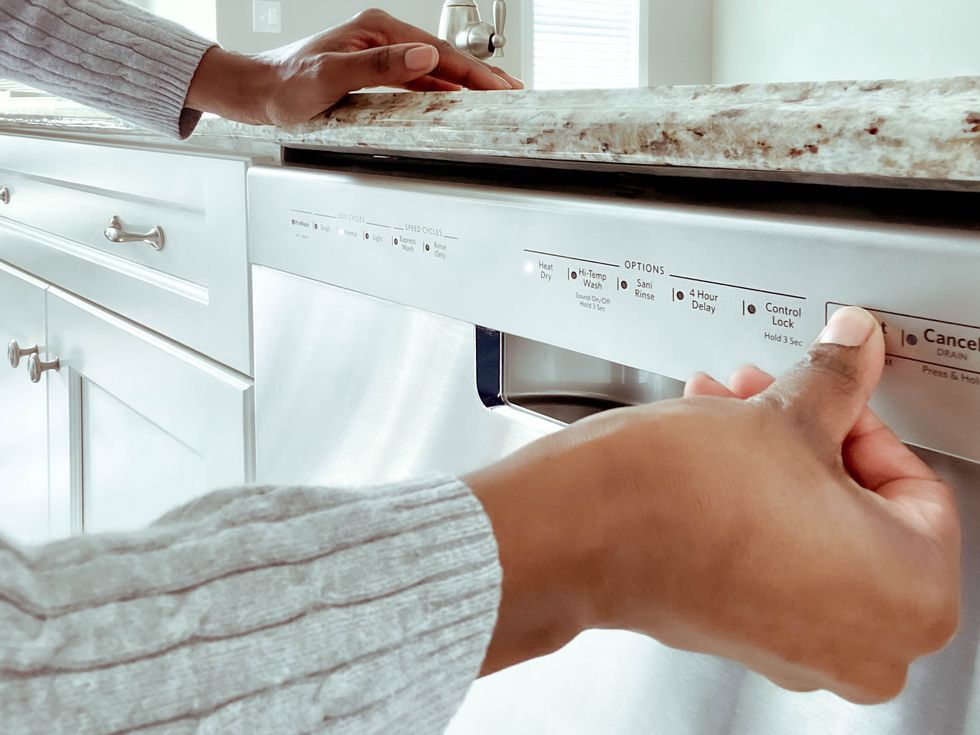 woman starts dishwasher