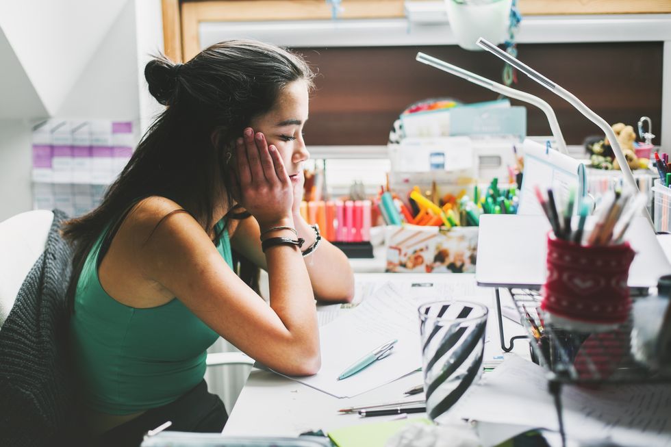 young woman sad at a work desk