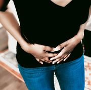 woman suffers pelvic pain from adenomyosis, endometriosis, fibroids or other cause