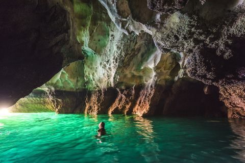 woman swimming in koh mook's emerald cave, thailand