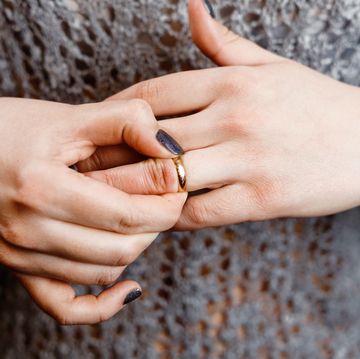 woman takes off an engagement ring, family conflict,  close-up