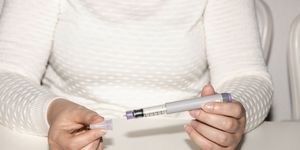 insulin injection pen or insulin cartridge pen for diabetics medical equipment for diabetes parients woman holding an injection pen for diabetic