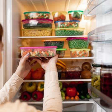 woman taking food from freezer