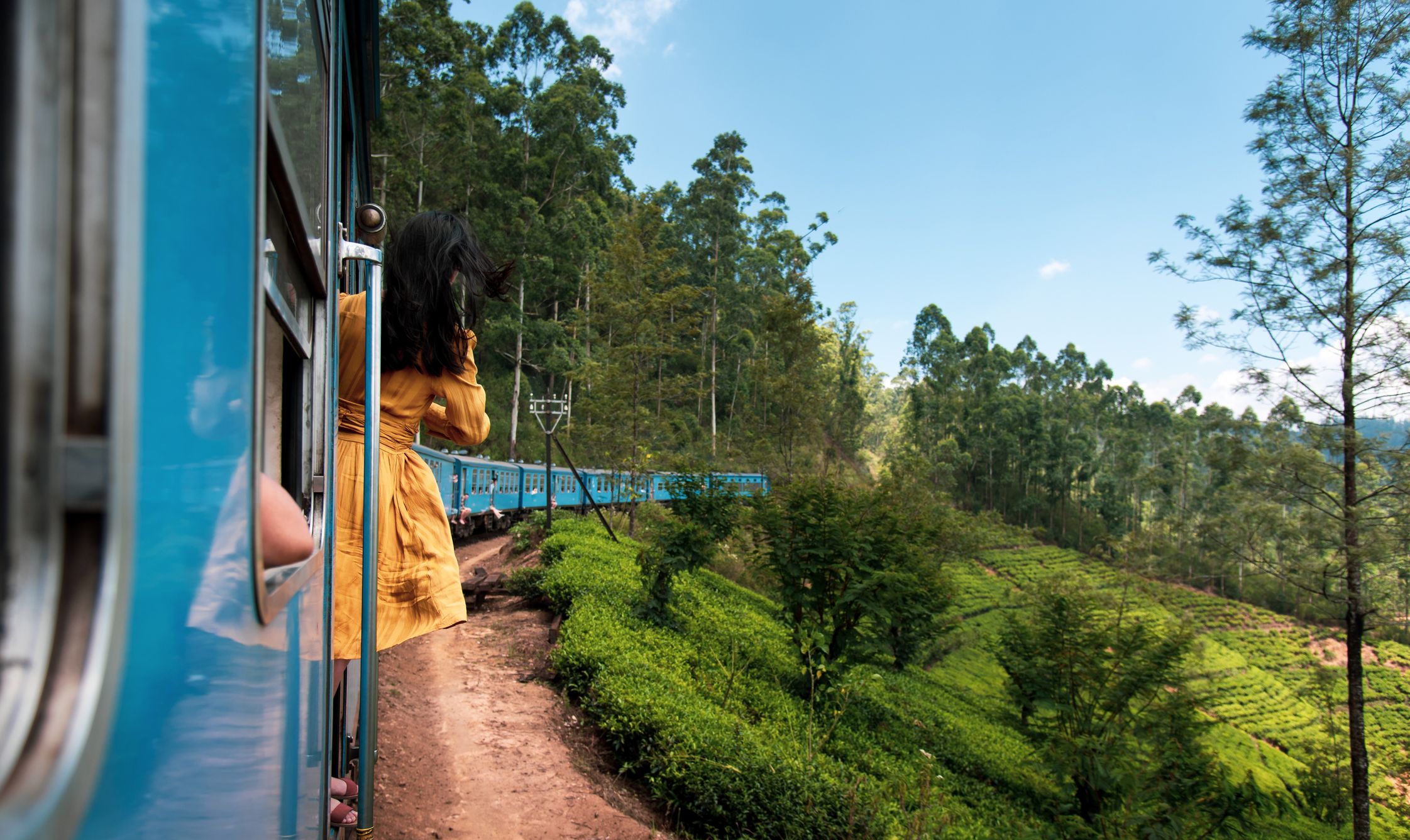 https://hips.hearstapps.com/hmg-prod/images/woman-taking-the-train-ride-in-sri-lanka-tea-royalty-free-image-1676369207.jpg