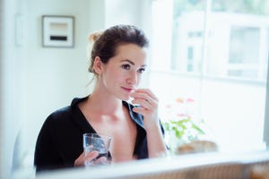 woman taking vitamins and supplements