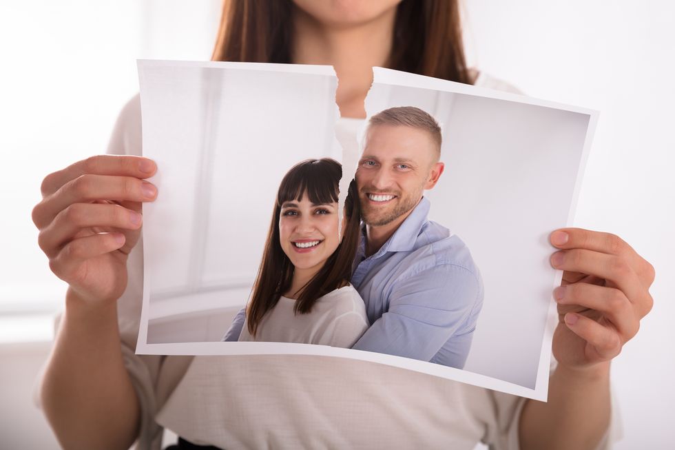 Woman Tearing Photo Of Happy Couple