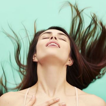woman throwing head back in ecstasy
