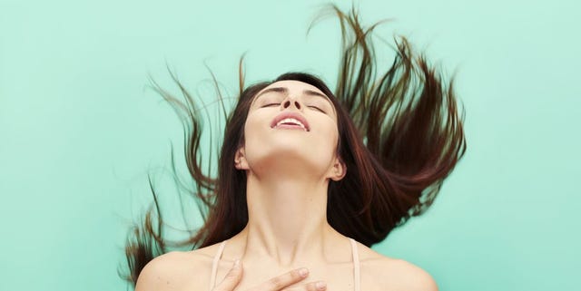 woman throwing head back in ecstasy