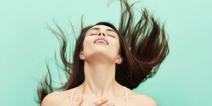 woman throwing head back in ecstasy