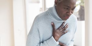 Woman touching chest in pain
