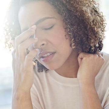 Woman touching her face