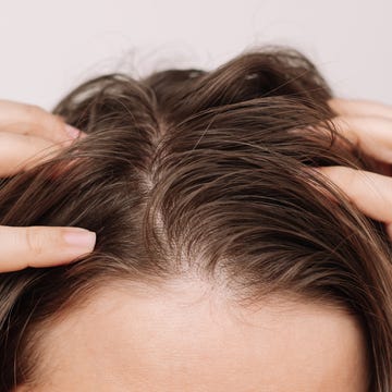 woman fingers touching scalp woman fingers touching scalp