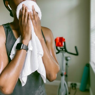 Woman Towels Off After Workout woman towels off after workout
