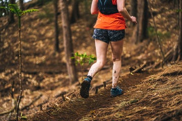 woman trail runner explores forest