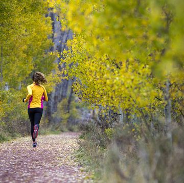 woman trail running in fall, escalante, utah, usa