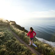 woman trail running near the ocean