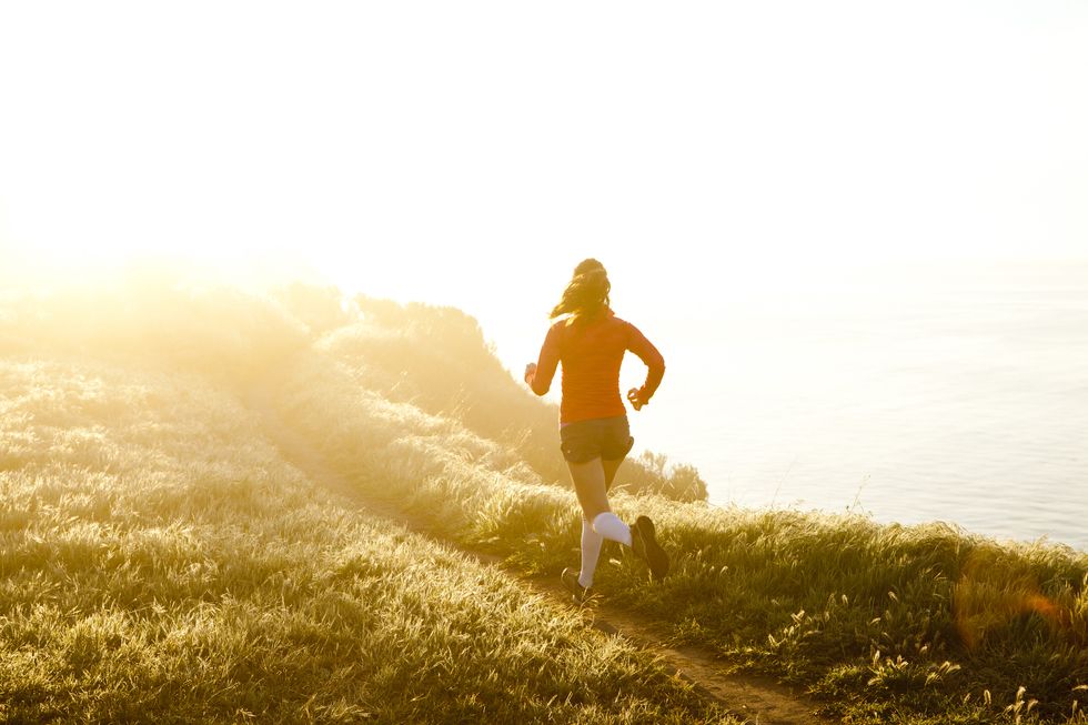 woman trail running near the ocean