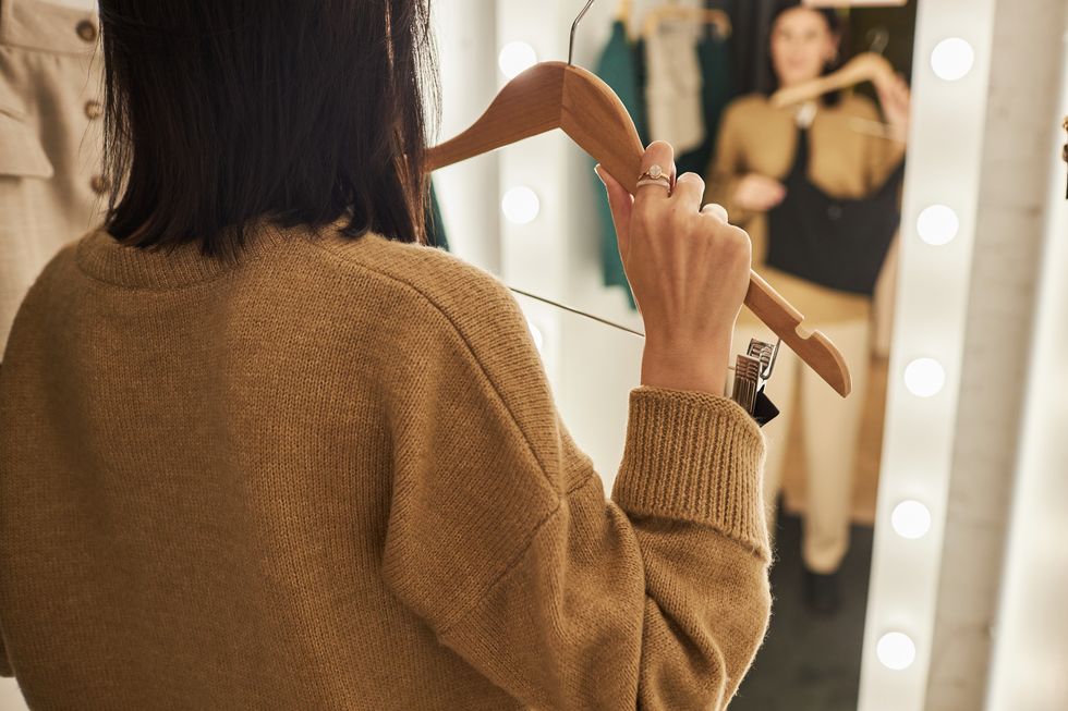 woman trying on clothes in dressing room