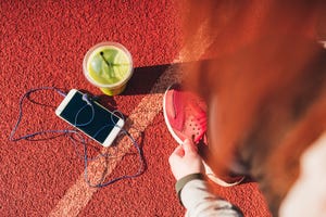 Woman tying shoelaces on stadium