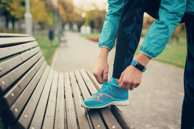 Woman tying up her shoe lace