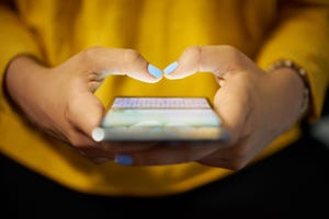 Woman Typing Phone Message On Social Network At Night