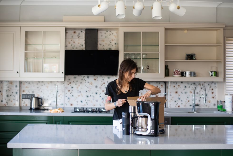 woman unpacking in her new kitchen
