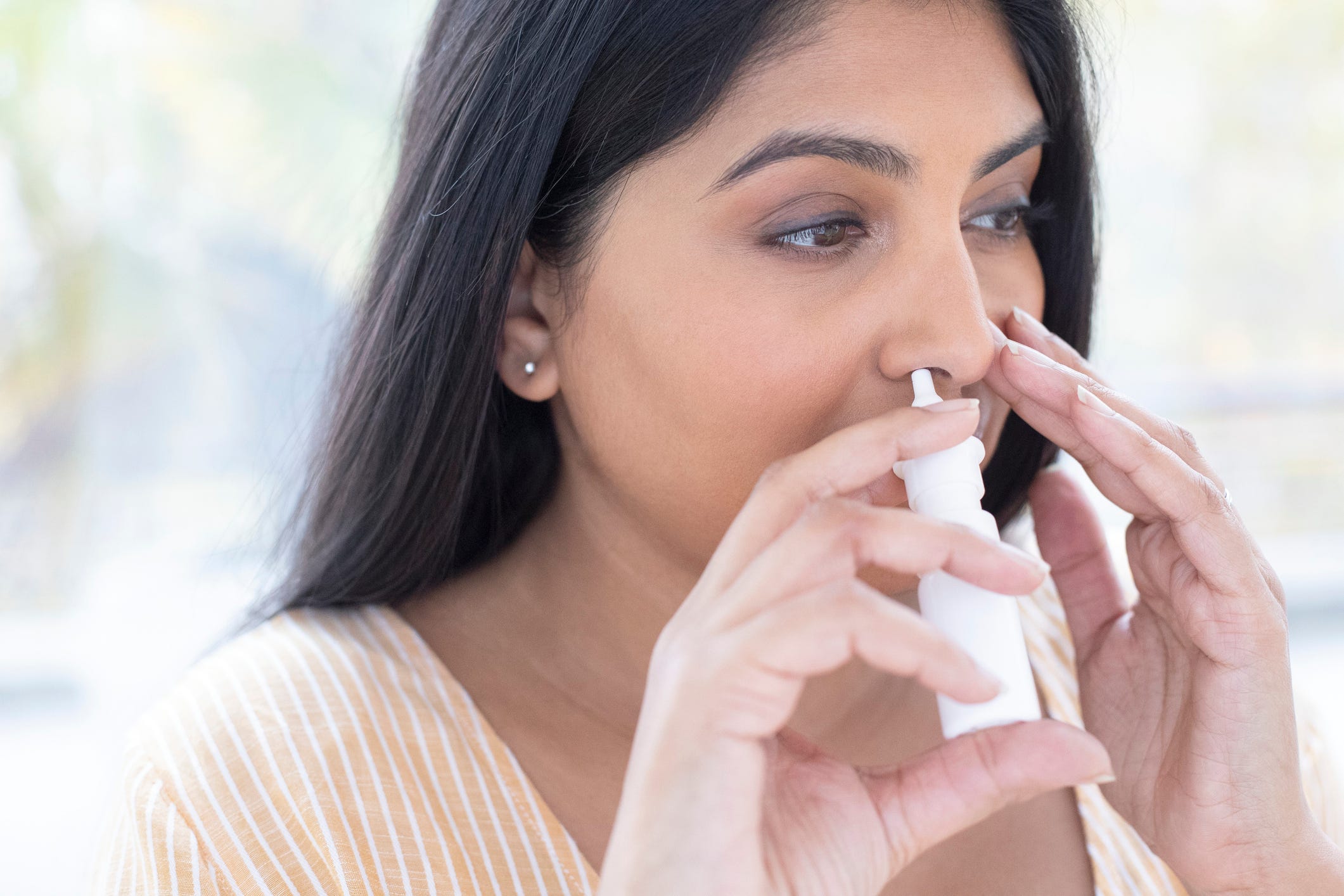 woman using a nasal spray