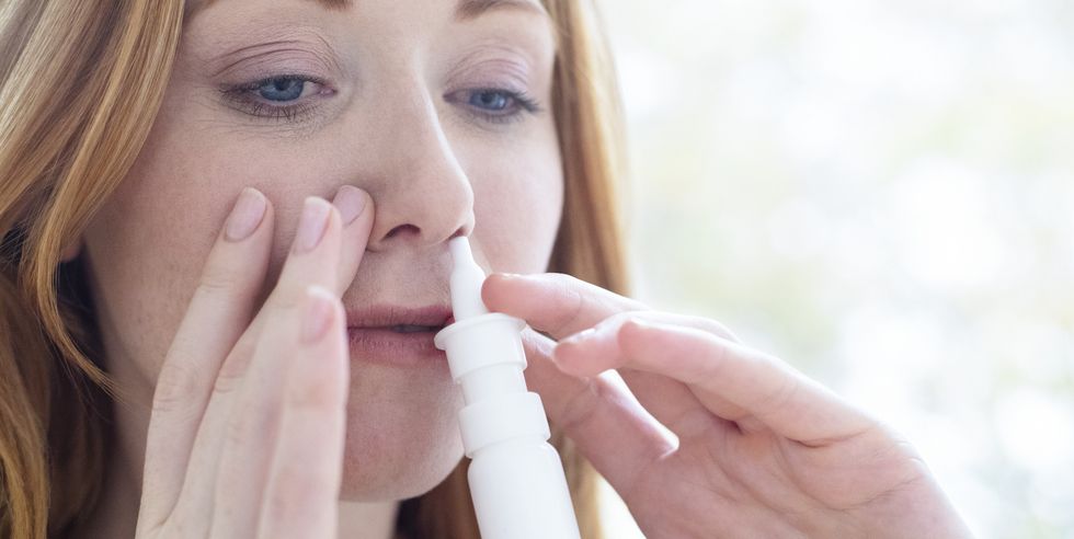 woman using a nasal spray