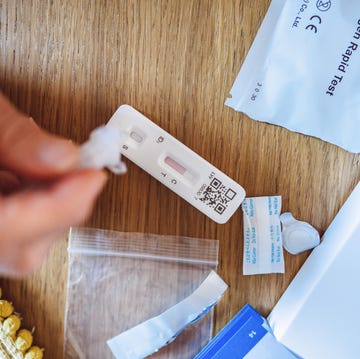 A woman using Covid-19 rapid self-test kit at home a woman using covid 19 rapid self test kit at home