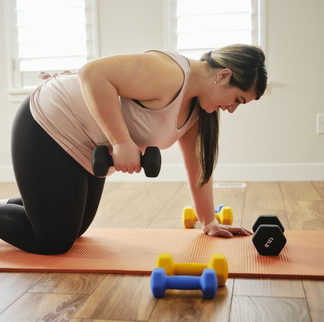 woman using exercise weights in a home