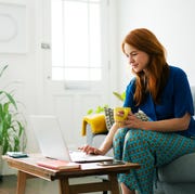 earth day sales woman using laptop from sofa