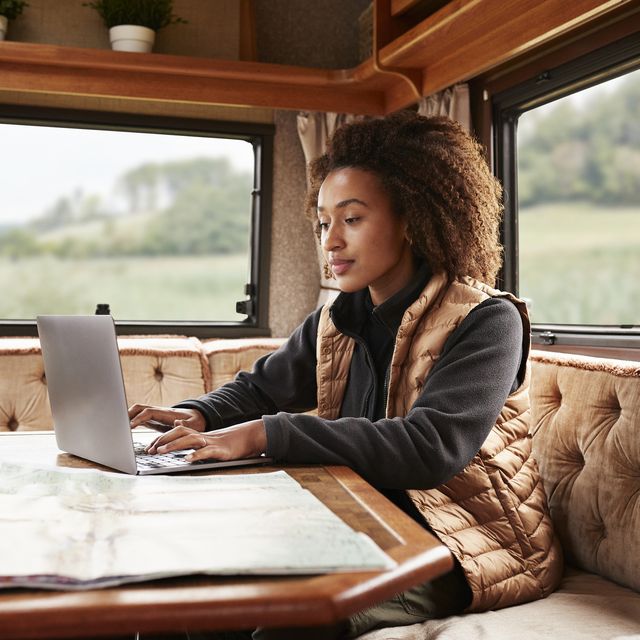 woman using laptop in camper van