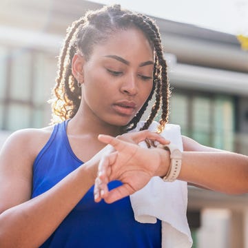 Woman using smart watch before running woman using smart watch before running