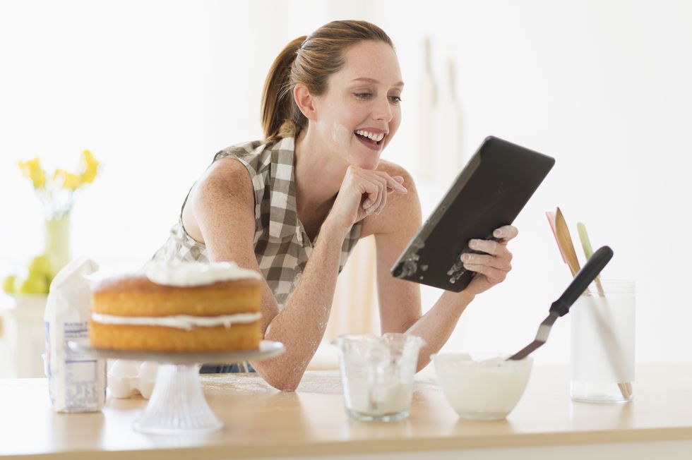 woman using tablet pc in kitchen