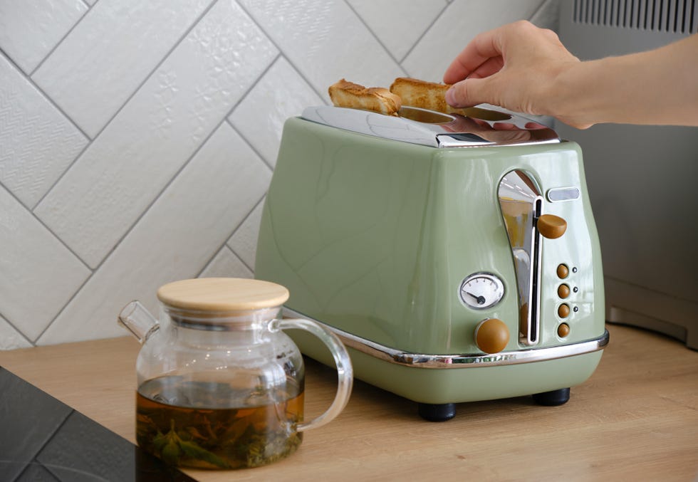 someone using a green toaster
