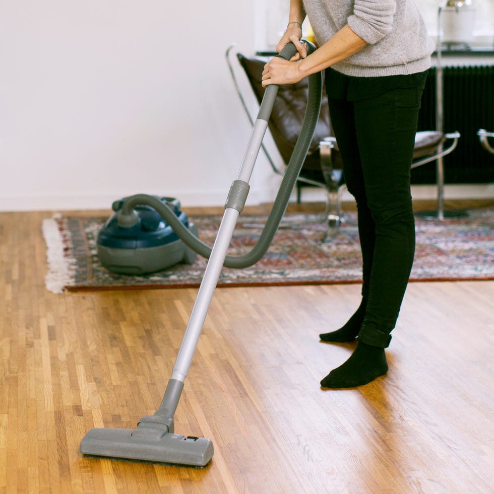 https://hips.hearstapps.com/hmg-prod/images/woman-vacuuming-hardwood-floor-at-home-royalty-free-image-1684252841.jpg?crop=0.836xw:0.558xh;0.136xw,0.344xh&resize=980:*