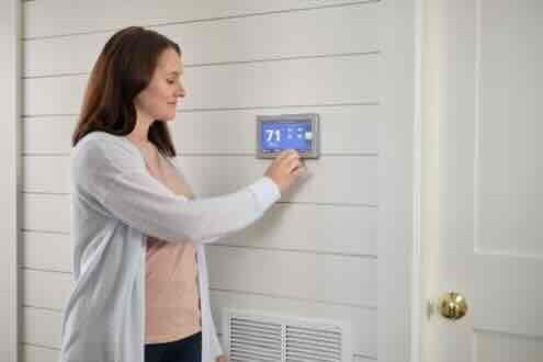 a woman with a thermostat