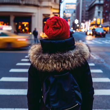 Woman waiting to cross the street in downtown Manhattan - New York City
