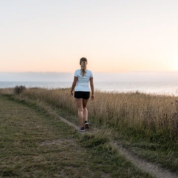 woman walking at dawn in the mountain woman walking at dawn in the mountain