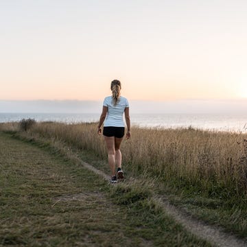 woman walking at dawn in the mountain